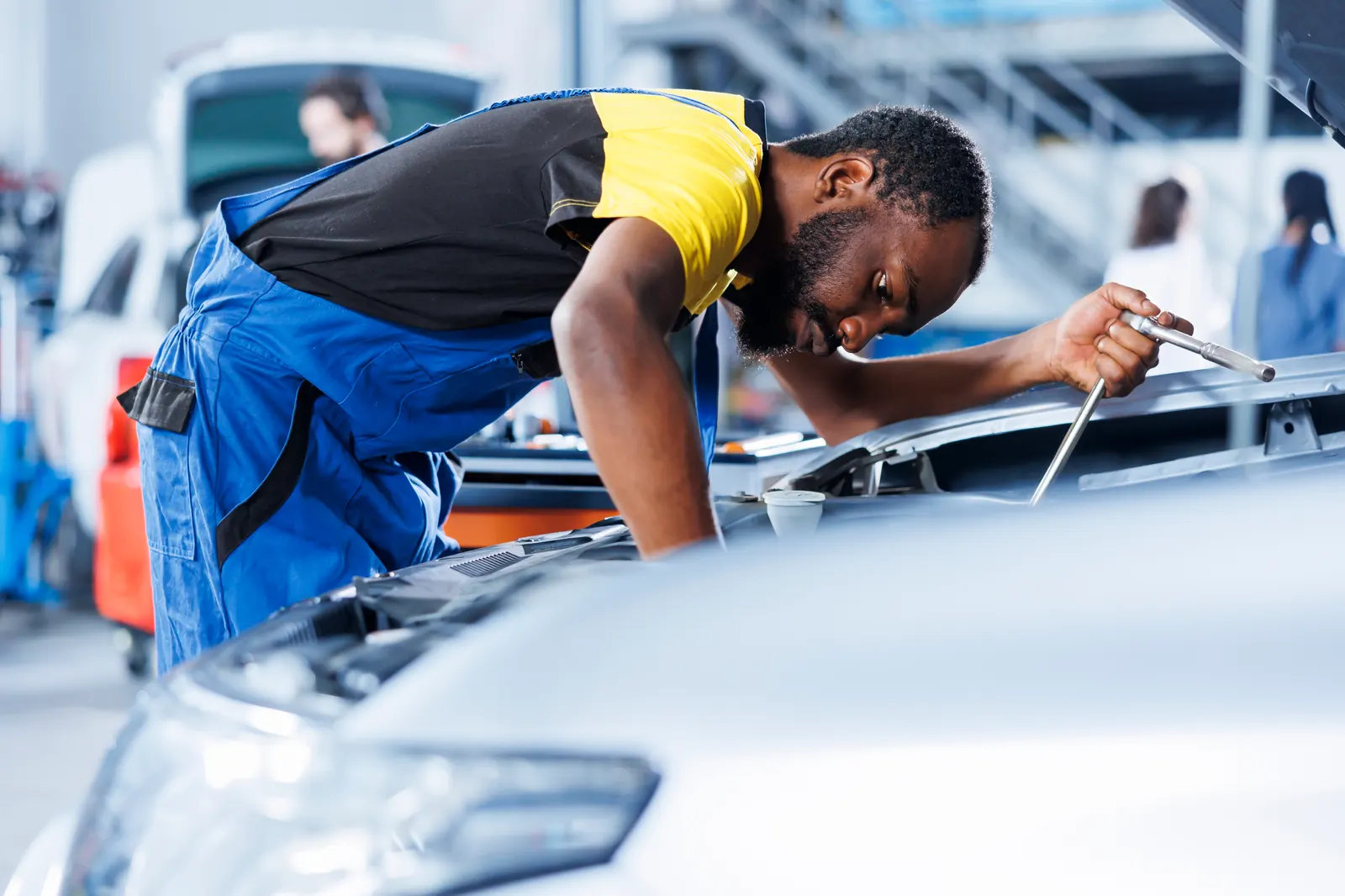 A technician checking a hire car before it goes out